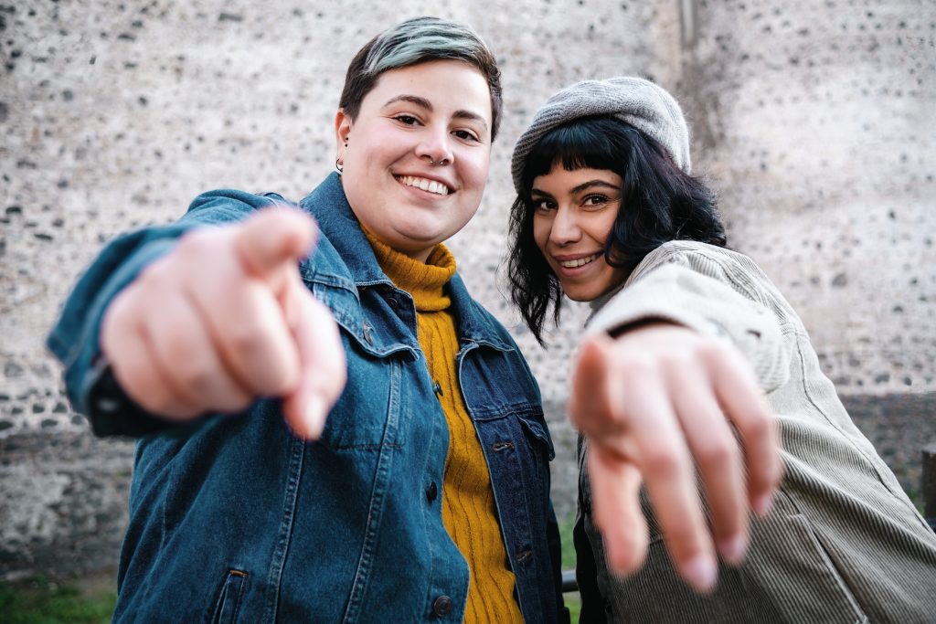 Young people pointing at camera. Mental Health Awareness Month.